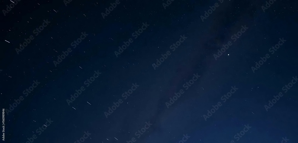 Fototapeta premium The night sky has shooting a star and the Milky Way in the background.