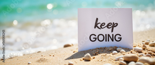Calm ocean waves gently touching motivational sign on the beach, encouragement