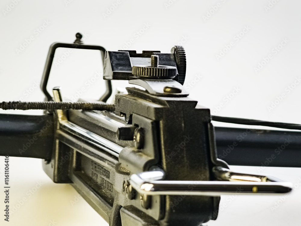 Sight of a Black training crossbow on a white background. Close-up. Sight of a Black training crossbow on a white background. Close-up.