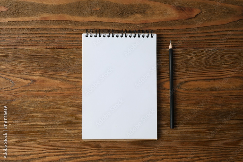 notebook with a pencil on a wooden background, space for text notebook with a pencil on a wooden background, space for text