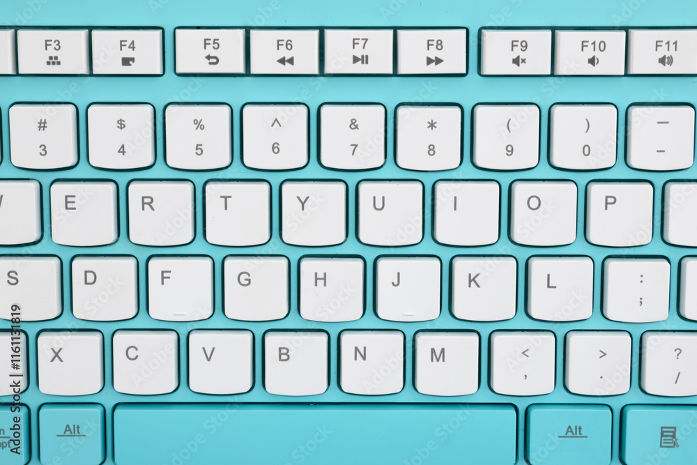 Closeup of white keyboard keys on a turquoise background Closeup of white keyboard keys on a turquoise background
