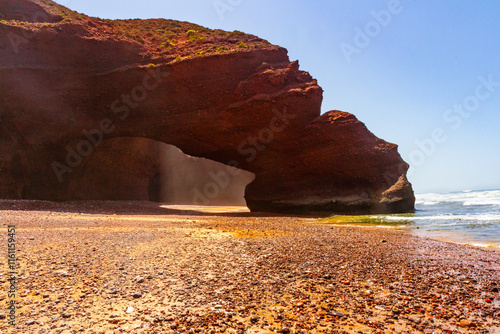 Spectacular natural red arch on atlantic ocean coast. Legzira ( or Lagzira, or Gzira) beach. Sidi Ifni, Morocco, Africa