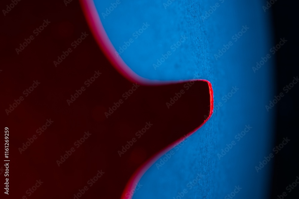 Abstract shape in blue with red edge on a reddish background with copy space Abstract shape in blue with red edge on a reddish background with copy space