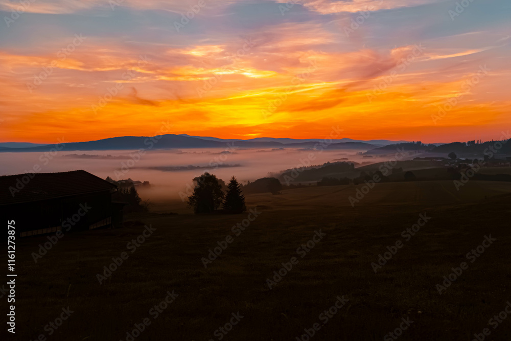 Foggy sunrise with dramatic clouds near Kirchberg im Wald, Regen, Bavarian Forest, Bavaria, Germany Foggy sunrise with dramatic clouds near Kirchberg im Wald, Regen, Bavarian Forest, Bavaria, Germany