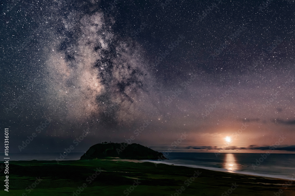 Fototapeta premium Pt Sur along Big Sur coast with Milky Way overhead while crescent moon is setting