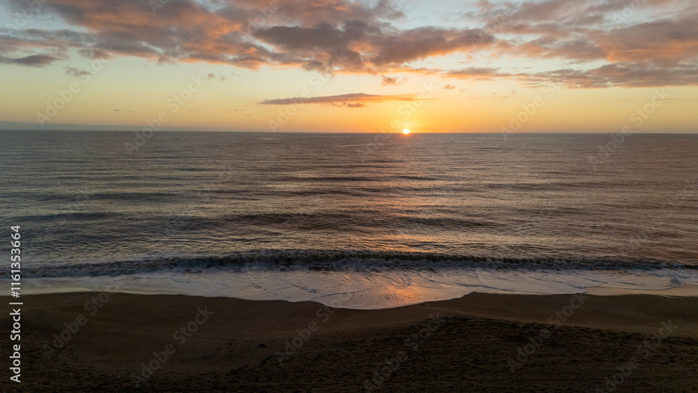 Drone aerial view of a sunset on a beach near Peniscola in Spain. Drone aerial view of a sunset on a beach near Peniscola in Spain.