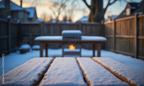 Snow-covered patio with glowing fire pit photo