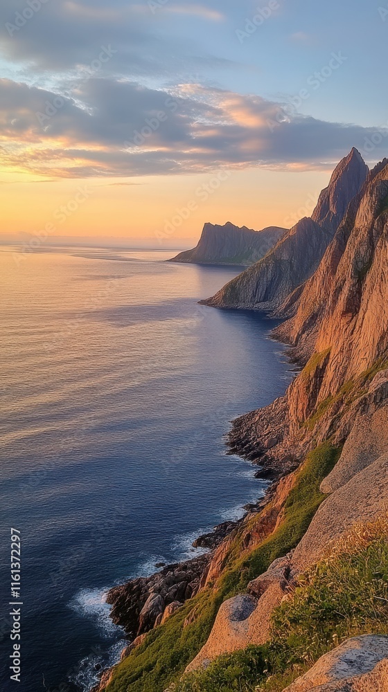 Fototapeta premium Stunning coastline view at sunset, showcasing rugged cliffs and calm sea. The warm colors of sunset reflect off the water, creating a serene atmosphere in nature.