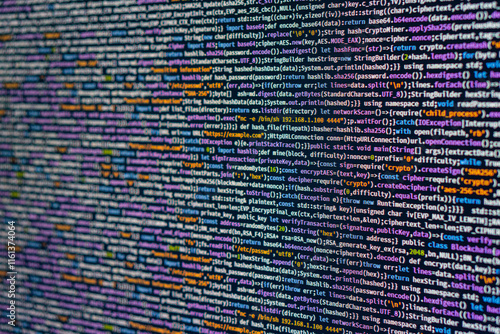 Image of a code editor displaying blurry lines of computer programming code, highlighting syntax elements like keywords, strings, numbers, and functions