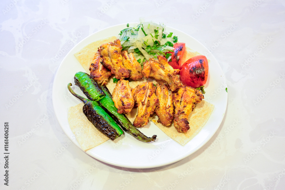 Chicken wings barbeque in a dish with BBQ grill sauce . Izgara tavuk kelebek sis kanat. Tavuk sis, gogus. Chicken wings barbeque in a dish with BBQ grill sauce . Izgara tavuk kelebek sis kanat. Tavuk sis, gogus.