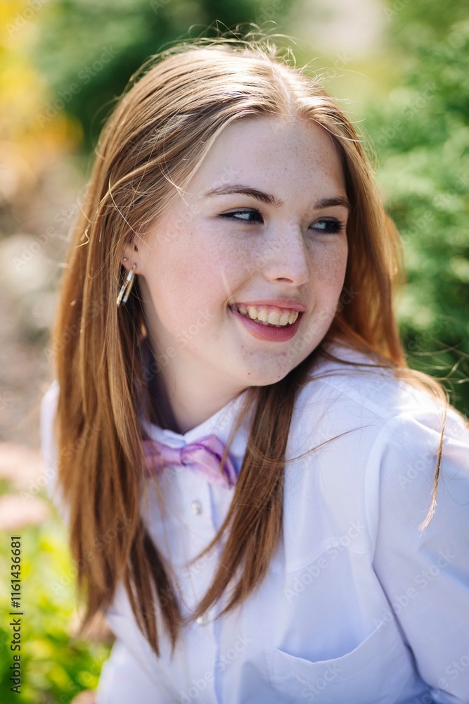 Smiling student in a bow tie posing for a portrait on the first day of school Smiling student in a bow tie posing for a portrait on the first day of school