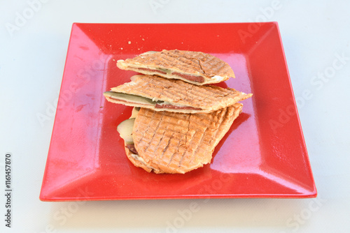 Turkish karisik atom kare  tost ( kasarli bazlama tost) . Sucuklu, Kasarli,  cheddarli, kavurmali karisik tost. Flat baked bread toasted. Karisik bazlama tost . photo