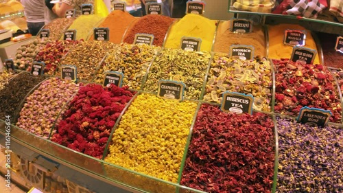 Footage of the Egyptian or Spice Bazaar in Istanbul, the shot moves over various tea and spices