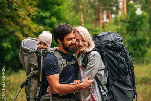 Wallpaper Mural Happy family on a hike with a child in a travel backpack. laugh, smile, get together and have a good time together Torontodigital.ca
