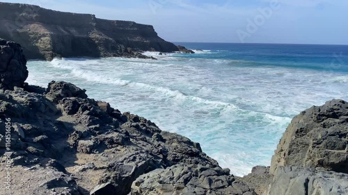 On the dramatic coast in Los Molinos on Fuerteventura island. It is home to a lovely beach and some caves that can only be accessed at low tide. photo