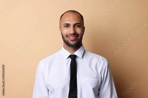 Portrait of businessman with necktie on beige background