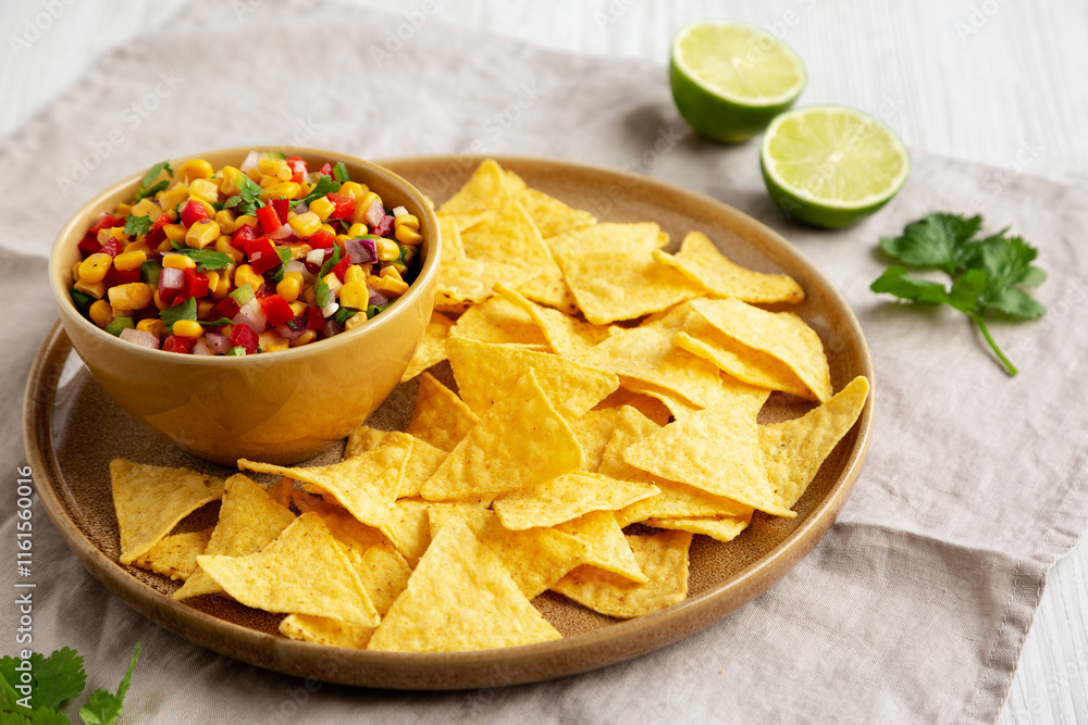 Homemade Corn Salsa with Tortilla Chips on a Plate, side view. Homemade Corn Salsa with Tortilla Chips on a Plate, side view.