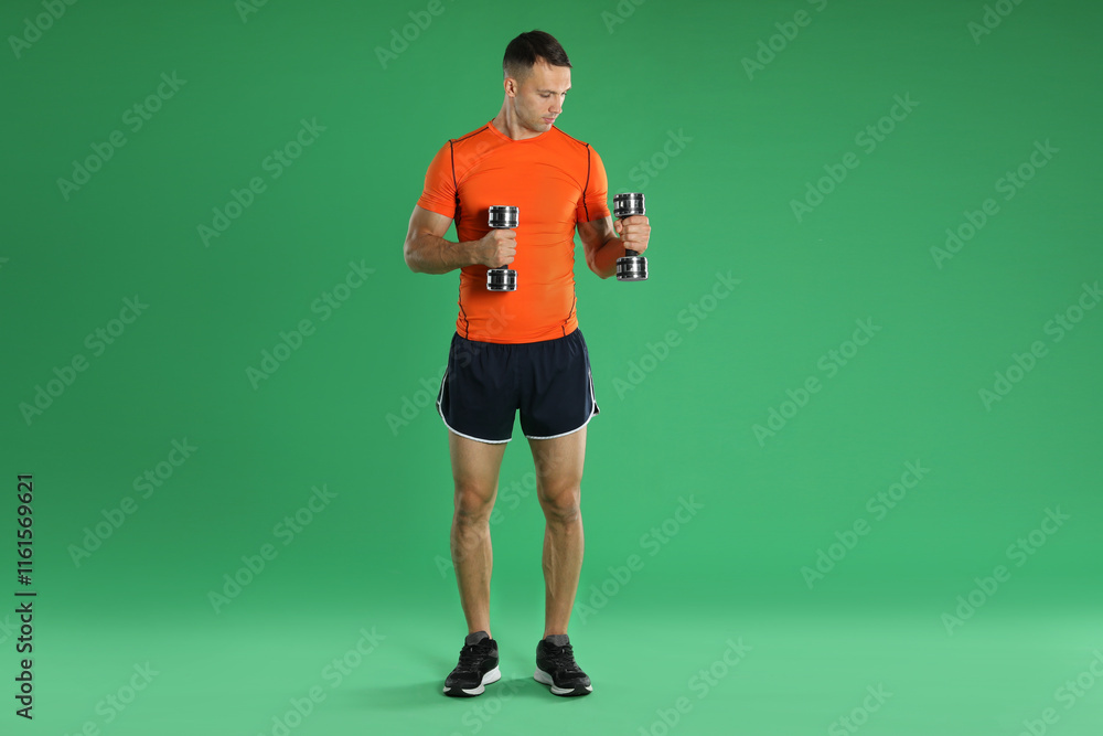 Man exercising with dumbbells on green background Man exercising with dumbbells on green background