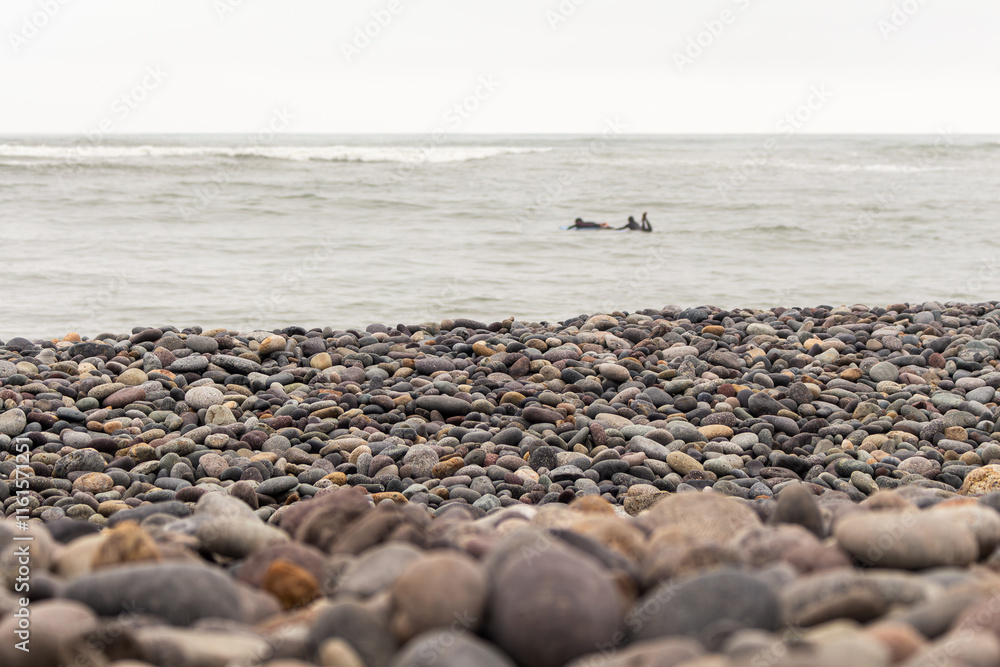 Surfers on Miraflores beach with guitar stones in Lima, Peru. Surfers on Miraflores beach with guitar stones in Lima, Peru.