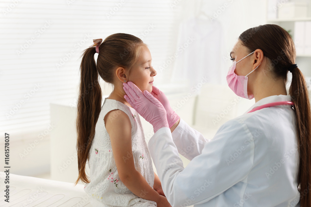 Doctor examining girl's throat in clinic during appointment Doctor examining girl's throat in clinic during appointment