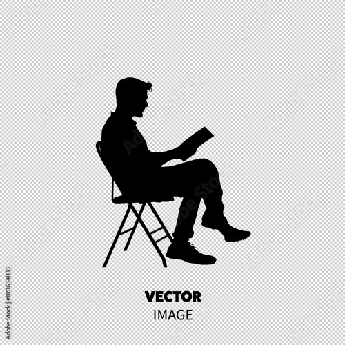 Silhouette of a young male reading a book while sitting on a chair.