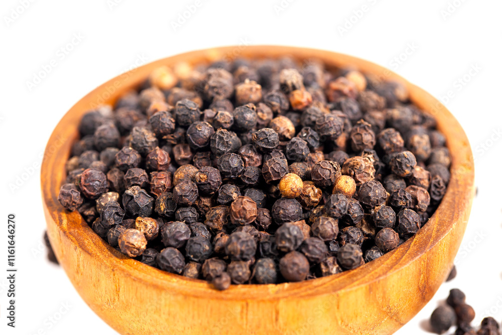 Black peppercorns (black pepper) in a wooden bowl isolated on a white background Black peppercorns (black pepper) in a wooden bowl isolated on a white background