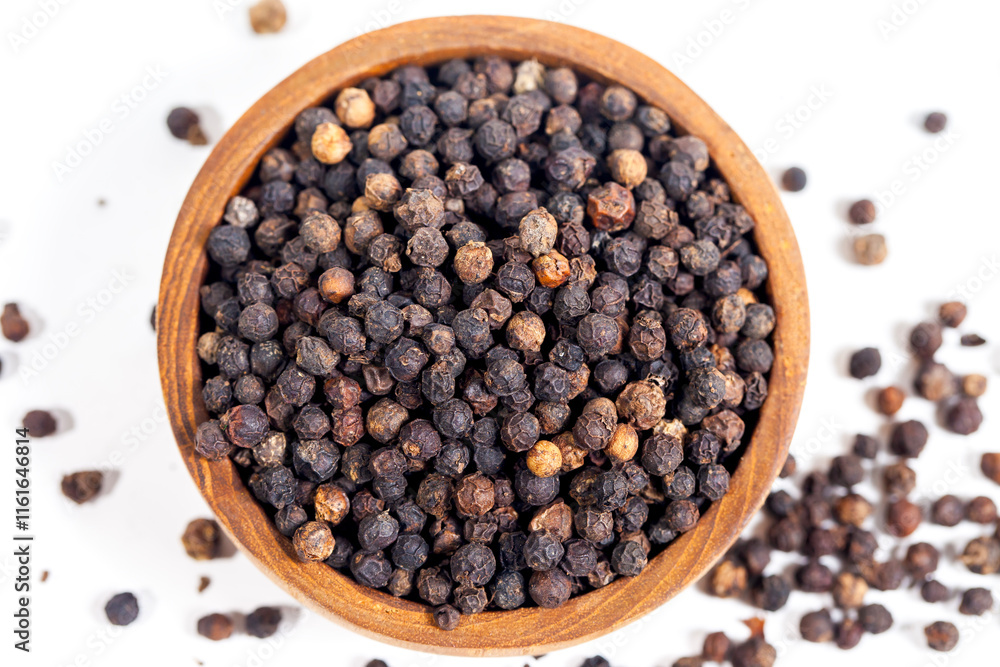 Black peppercorns (black pepper) in a wooden bowl isolated on a white background Black peppercorns (black pepper) in a wooden bowl isolated on a white background