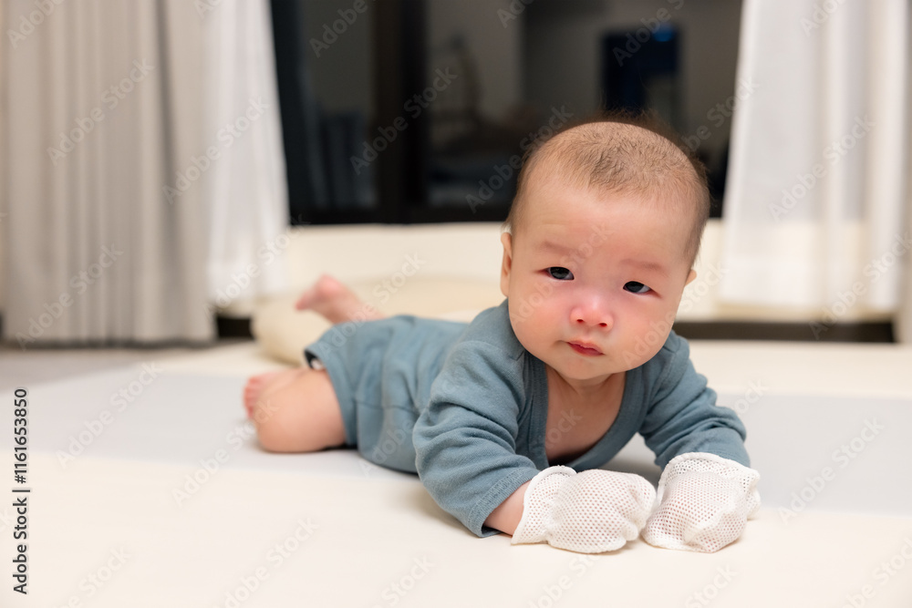 Newborn baby resting peacefully with mittens Newborn baby resting peacefully with mittens
