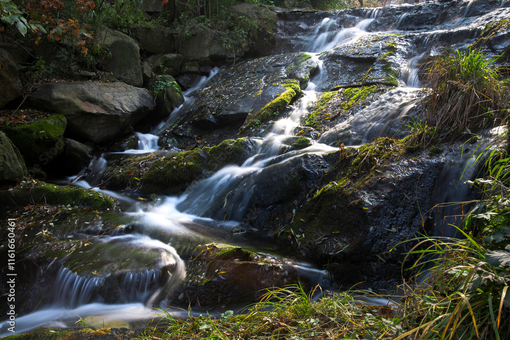 Rocks, water flow, and moss in the stream Rocks, water flow, and moss in the stream