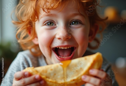 Adorable red hair child enjoying crepes during a festive Maslenitsa breakfast photo