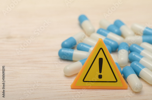 the warning triangle emphasizes the importance of following dosage instructions and seeking medical advice. photo