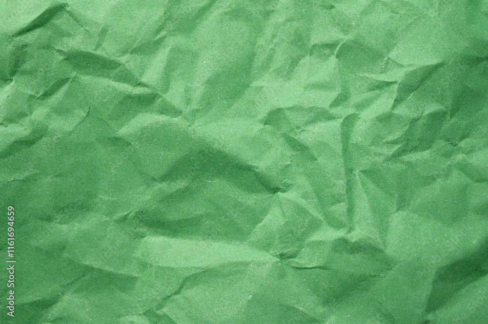 Obraz premium Full frame shot of crumpled light green paper sheet texture and background.