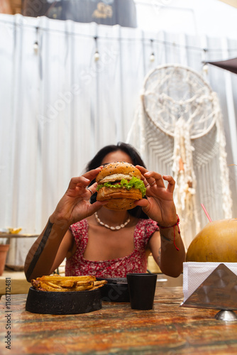 Woman Enjoying a Cheeseburger with Fries photo