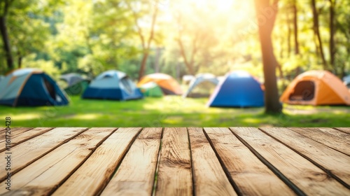 Wood table and Blurred camping and tents in forest.