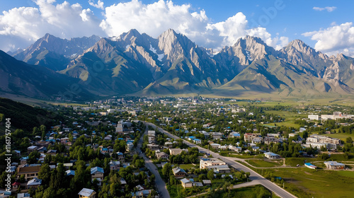 Fototapeta Naklejka Na Ścianę i Meble -  Aerial view of Cholpon-Ata city surrounded by mountains in Kyrgyzstan