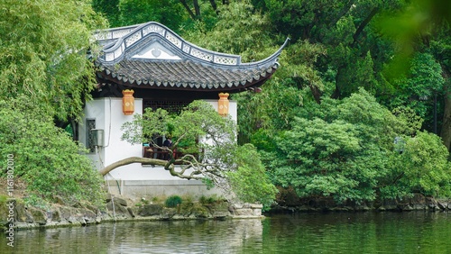 Summer tranquility at Gu Yiyuan Garden in Jiangnan, showcasing lush greenery and traditional architecture photo