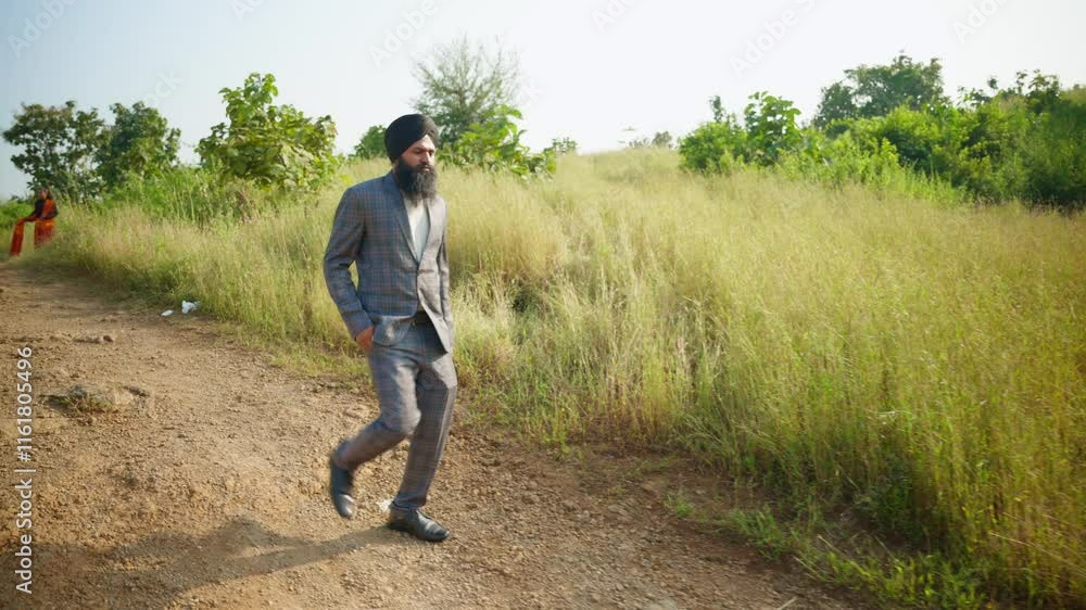 Bearded men walks by pathway side of greenery Bearded men walks by pathway side of greenery