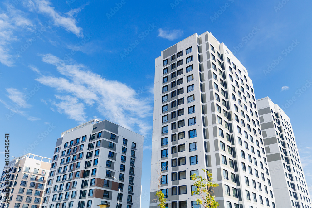 Modern white high-rise apartment buildings under clear blue sky Modern white high-rise apartment buildings under clear blue sky