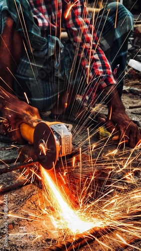 Electric wheel grinding cuting on steel. sparks from cutting