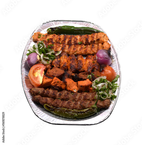 Mixed grill large platter with tomato, onion and green chilli in a plate