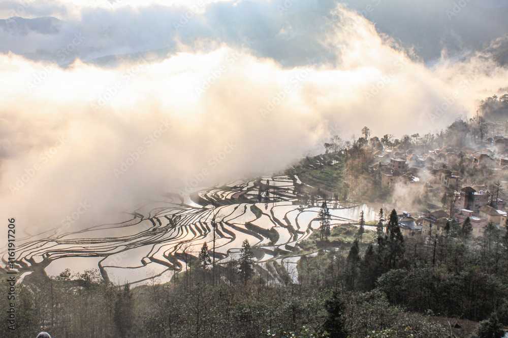 Fototapeta premium Terraced rice field in water season of Hani ethnic people in Yuanyang, Yunnan province, China the terraced fields have been officially acknowledged by UNESCO as a World Cultural and Natural HeritageSi
