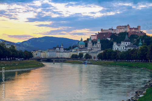 Obraz na płótnie The city of Salzburg with historical buildings bisected by a winding Salzach River and mountain ranges in the background w salonie