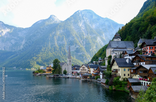Obraz na płótnie Idyllic village of Hallstatt, Austria, nestled along the shore of a serene alpine lake, with majestic mountains enveloping the village w salonie