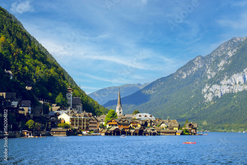 Obraz na płótnie Idyllic village of Hallstatt, Austria, nestled along the shore of a serene alpine lake, with majestic mountains enveloping the village w salonie