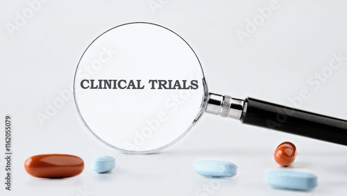 A magnifying glass highlights the phrase clinical trials, symbolizing the critical role of research in evaluating new medications photo