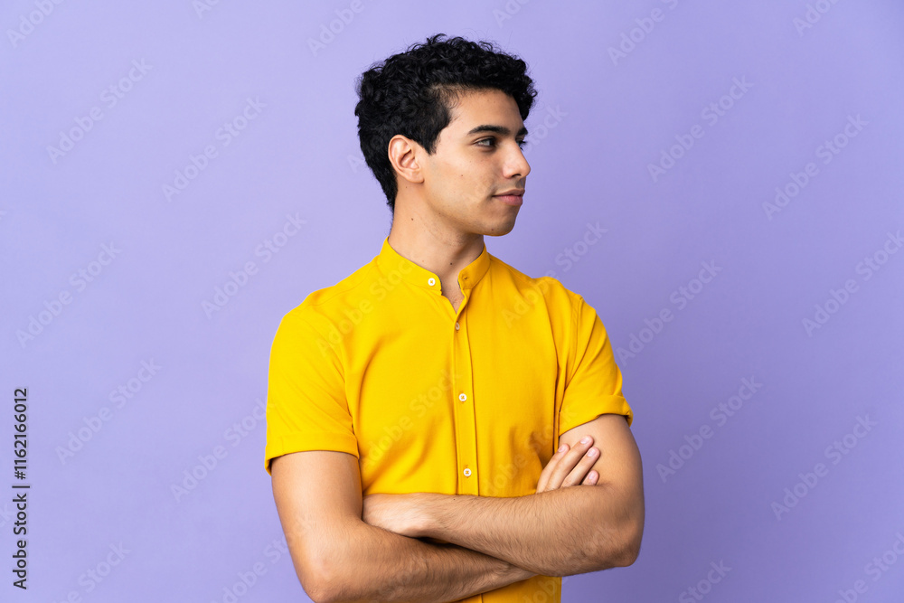 Young Venezuelan man isolated on purple background looking to the side Young Venezuelan man isolated on purple background looking to the side