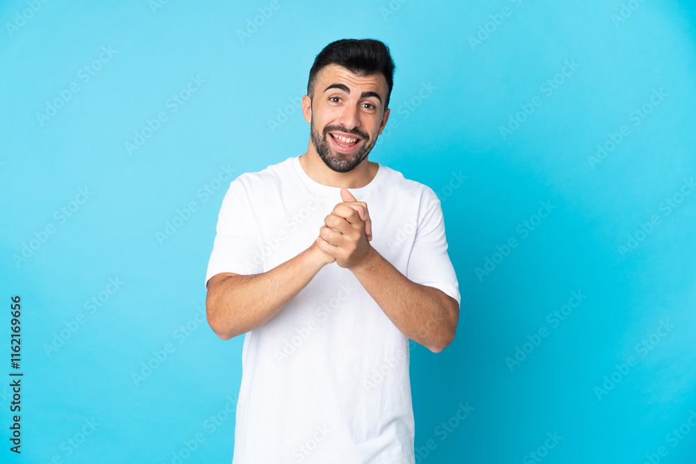 Caucasian man over isolated blue background laughing Caucasian man over isolated blue background laughing