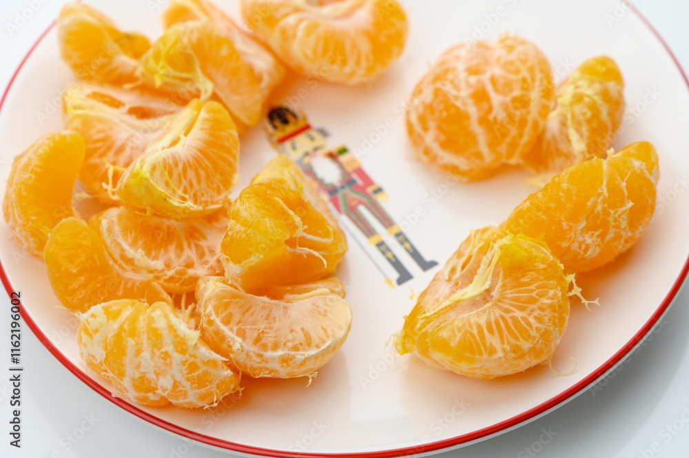 Freshly peeled orange segments arranged artistically on a decorative plate for a vibrant snack Freshly peeled orange segments arranged artistically on a decorative plate for a vibrant snack