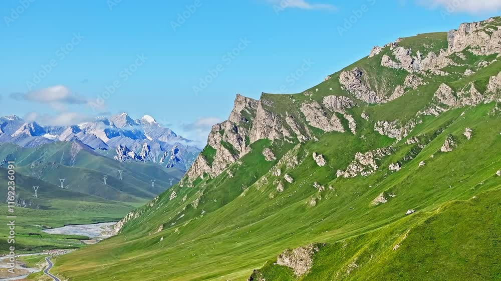 Green grassland pasture and mountain nature landscape in the morning. Beautiful mountain scenery along the Duku Highway in Xinjiang, China. Green grassland pasture and mountain nature landscape in the morning. Beautiful mountain scenery along the Duku Highway in Xinjiang, China.