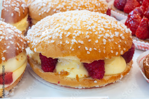 Cake Tarte tropezienne or La Tarte de Saint-Tropez - dessert pastry consisting of filled brioche with cream and fresh red berries photo